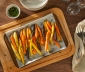 Roasted carrots sitting on a parchment lined baking sheet 