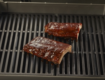 rack of ribs sitting on grill grates