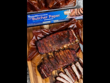 Two slabs of ribs alongside a box of Reynolds Kitchens Butcher Paper